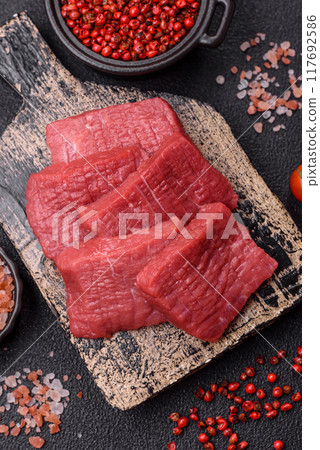 Juicy fresh raw beef meat with salt, spices and herbs 117692586