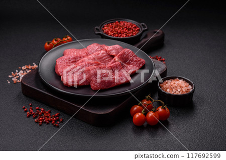 Juicy fresh raw beef meat with salt, spices and herbs 117692599