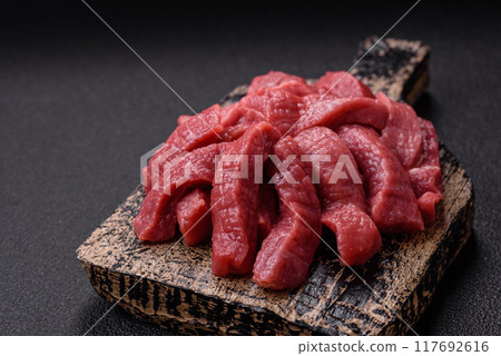 Juicy fresh raw beef meat with salt, spices and herbs Juicy fresh raw beef meat with salt, spices and herbs 117692616