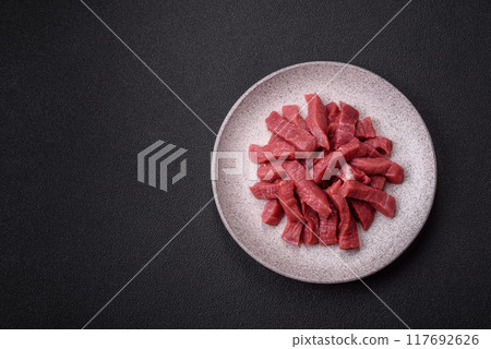 Juicy fresh raw beef meat with salt, spices and herbs 117692626