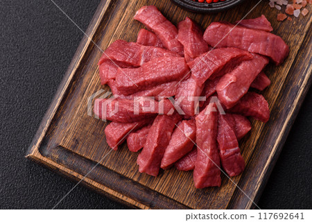 Juicy fresh raw beef meat with salt, spices and herbs 117692641