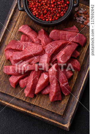 Juicy fresh raw beef meat with salt, spices and herbs 117692642