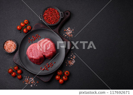 Fresh juicy raw beef medallions with salt and spices 117692671