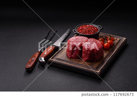 Fresh juicy raw beef medallions with salt and spices Fresh juicy raw beef medallions with salt and spices 117692673