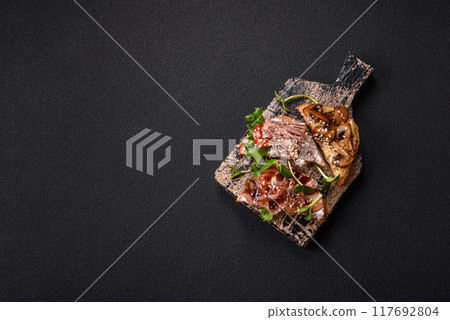 Variation of several toasts or bruschetta with prosciutto, mushrooms and veal Variation of several toasts or bruschetta with prosciutto, mushrooms and veal 117692804