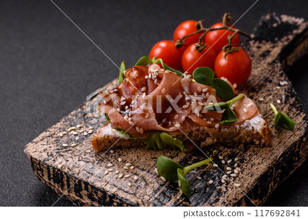 Variation of several toasts or bruschetta with prosciutto, mushrooms and veal 117692841