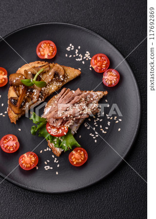 Variation of several toasts or bruschetta with prosciutto, mushrooms and veal 117692869
