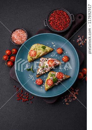 Crispy sandwich or bruschetta with guacamole, tuna and flax seeds 117692917