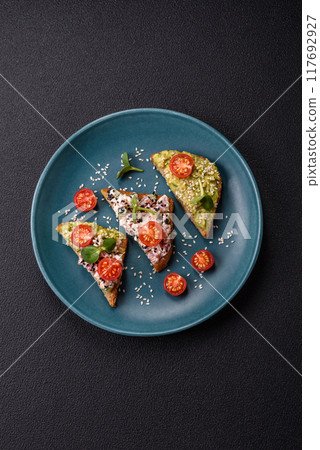 Crispy sandwich or bruschetta with guacamole, tuna and flax seeds 117692927