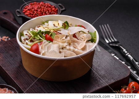 Delicious fresh caesar salad in a bowl with chicken breast, egg, tomatoes 117692957