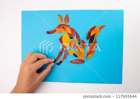 Autumn craft for kid, fox made of leaf on blue background, animal clip art collage made of dry dead leaves, fall DIY idea, educational art project, seasonal decoration, nature-themed children's craft 117693644