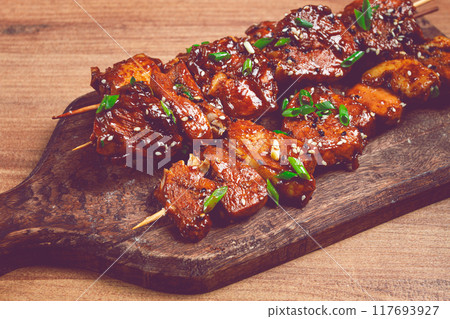 yakitori chicken kebab, on skewers, with green onions and sesame seeds, top view, without people, yakitori chicken kebab, on skewers, with green onions and sesame seeds, top view, without people, 117693927