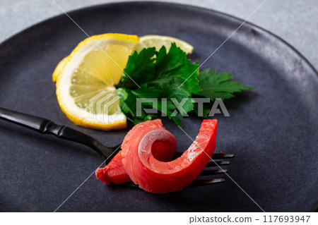 chum salmon, cold smoked, on a fork, with lemon and parsley, top view, close-up, no people, 117693947