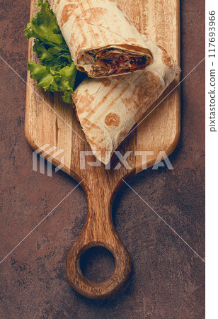 cut shawarma, 2 pieces, on a cutting board, close-up, cut shawarma, 2 pieces, on a cutting board, close-up, 117693966