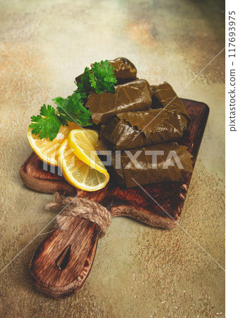 dolma, minced meat with rice, in grape leaves, minced meat rolls, on a chopping board, top view, no people, dolma, minced meat with rice, in grape leaves, minced meat rolls, on a chopping board, top view, no people, 117693975