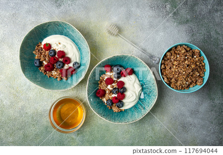 Breakfast, two bowls, yogurt, muesli with berries, and honey, homemade, no people, Breakfast, two bowls, yogurt, muesli with berries, and honey, homemade, no people, 117694044