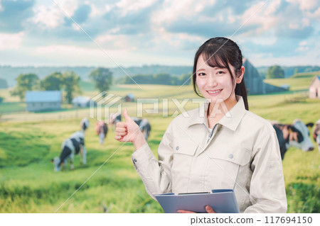 A young woman in work clothes working on a farm 117694150