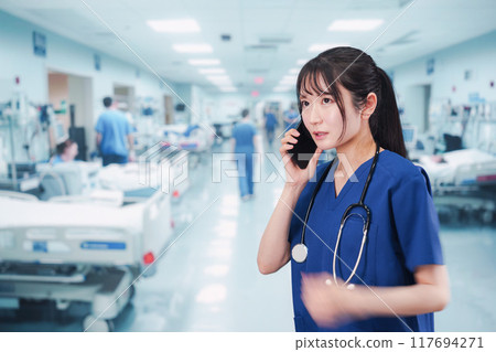A young female doctor busy dealing with an emergency case 117694271