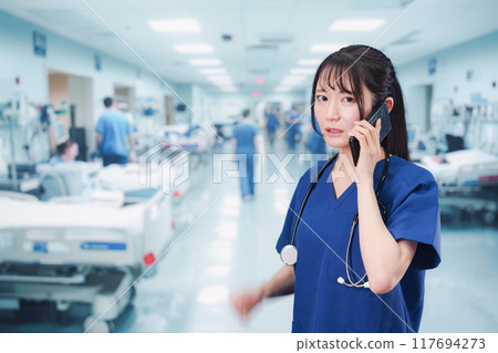 A young female doctor busy dealing with an emergency case A young female doctor busy dealing with an emergency case 117694273