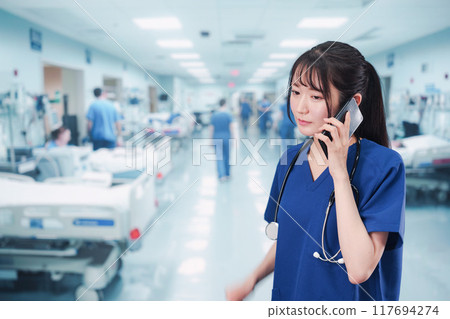 A young female doctor busy dealing with an emergency case A young female doctor busy dealing with an emergency case 117694274