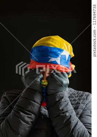 Symbol of repression, hooded fighting for freedom, resistance for democracy in Venezuela, violation of human rights 117694738