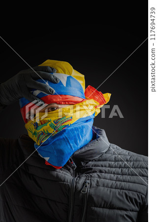 Concept symbol of repression, hooded fighting for freedom, resistance for democracy in Venezuela, violation of human rights 117694739