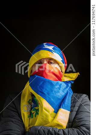 Symbol of repression, hooded fighting for freedom, resistance for democracy in Venezuela 117694741