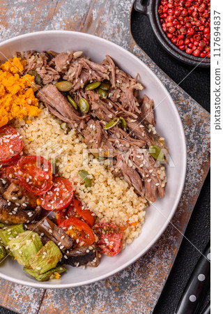 Bowl of food with beef, bulgur, tomatoes, mushrooms, zucchini 117694837