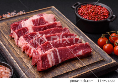 Fresh raw beef cut into slices with salt, spices Fresh raw beef cut into slices with salt, spices 117694888