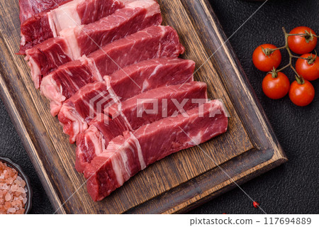 Fresh raw beef cut into slices with salt, spices 117694889
