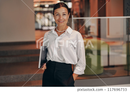 A confident Businesswoman showcasing her professional prowess in a contemporary office setting 117696733