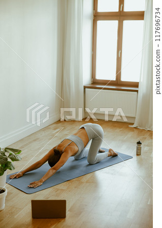 Engaging in Yoga Practice Within a Calm and Serene Indoor Space to Enhance Wellbeing 117696734
