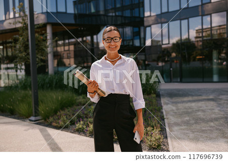 Confident and Professional Woman Thriving in a Modern Office Environment and Setting Confident and Professional Woman Thriving in a Modern Office Environment and Setting 117696739