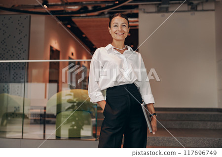 A Confident Businesswoman Thrives in a Modern Office Setting, Embracing Her Professionalism A Confident Businesswoman Thrives in a Modern Office Setting, Embracing Her Professionalism 117696749