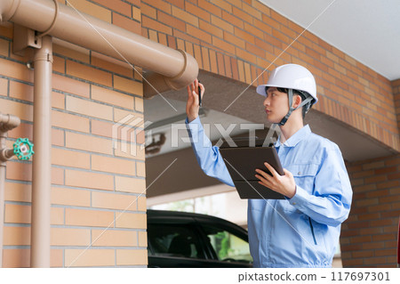 A worker inspecting the equipment 117697301