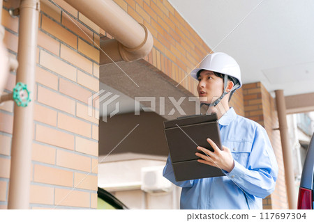 A worker inspecting the equipment 117697304