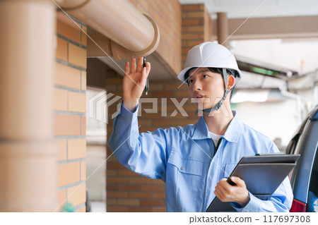 A worker inspecting the equipment A worker inspecting the equipment 117697308