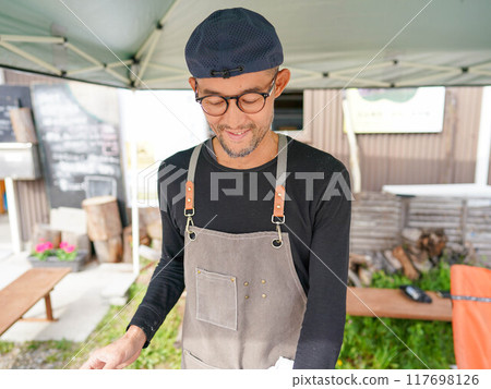 Man enjoying outdoor cooking Man enjoying outdoor cooking 117698126