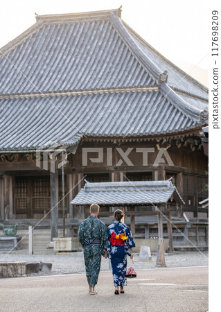 在三重縣龜山市關宿的街道上,一對身著浴衣的外國夫婦在地藏院前漫步。 在三重縣龜山市關宿的街道上,一對身著浴衣的外國夫婦在地藏院前漫步。 117698209