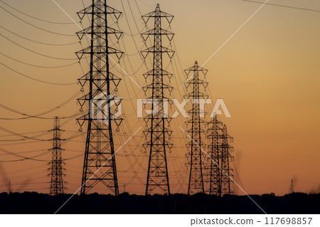 Silhouette of power lines against the morning glow Silhouette of power lines against the morning glow 117698857