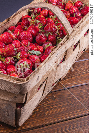 ripe strawberries in a wooden box on the table close up ripe strawberries in a wooden box on the table close up 117699017