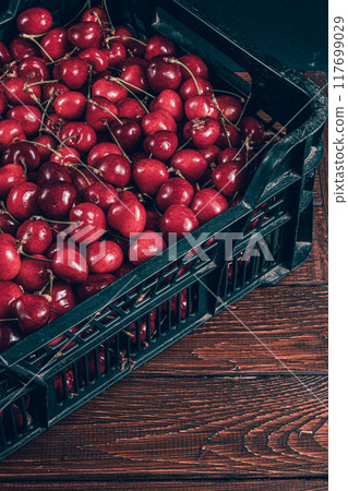 ripe cherries in a plastic box on the table top view ripe cherries in a plastic box on the table top view 117699029