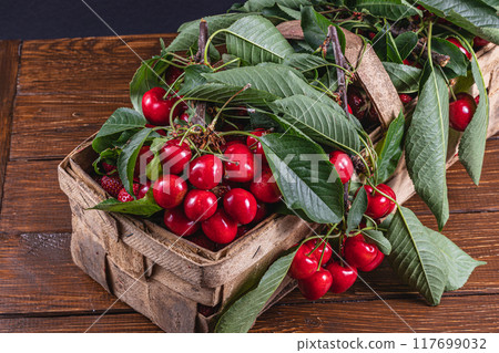 ripe cherries in a box on the table close up top view ripe cherries in a box on the table close up top view 117699032