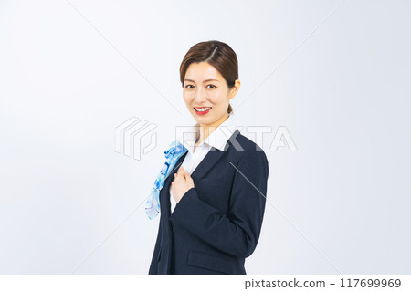 A woman in a suit smiling with her hand on her chest A woman in a suit smiling with her hand on her chest 117699969