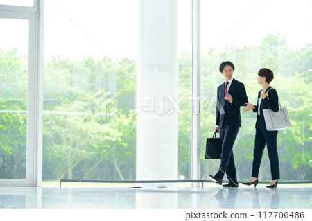 Male and female employees business image Male and female employees business image 117700486