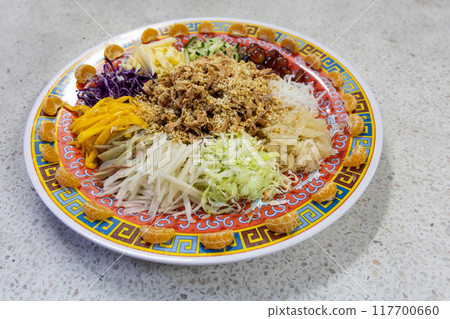 Serving of vegetarian Yusheng dish consisting vegetables and fruits for healthier diet during Chinese New Year celebration, suitable for vegan. 117700660