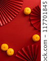 Chinese new year background design flat lay image with mandarin oranges and red paper fan 117701845