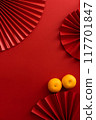 Chinese new year background design flat lay image with mandarin oranges and red paper fan 117701847