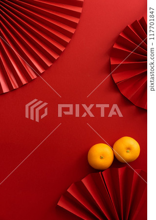 Chinese new year background design flat lay image with mandarin oranges and red paper fan 117701847