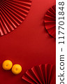 Chinese new year background design flat lay image with mandarin oranges and red paper fan 117701848